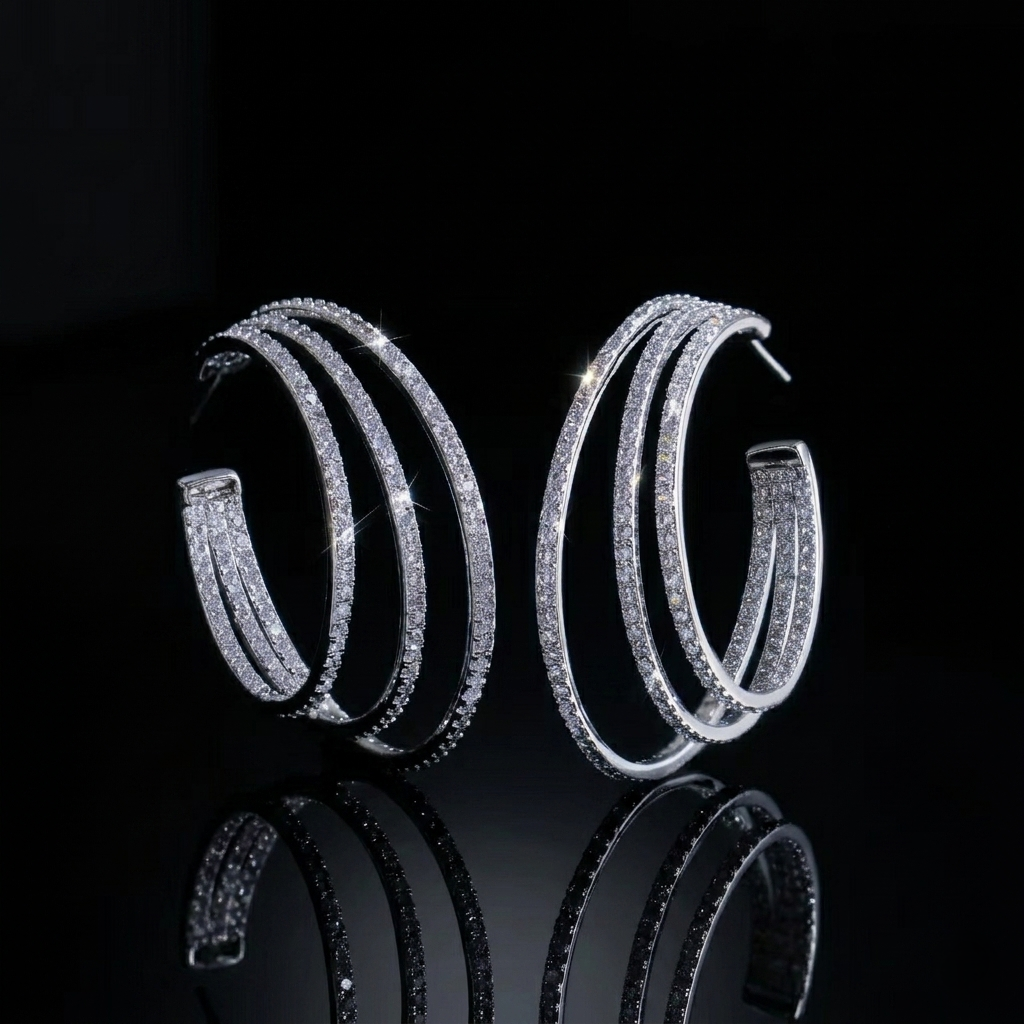 Pair of modern triple-layered hoop earrings in silver finish, encrusted with sparkling zirconia.