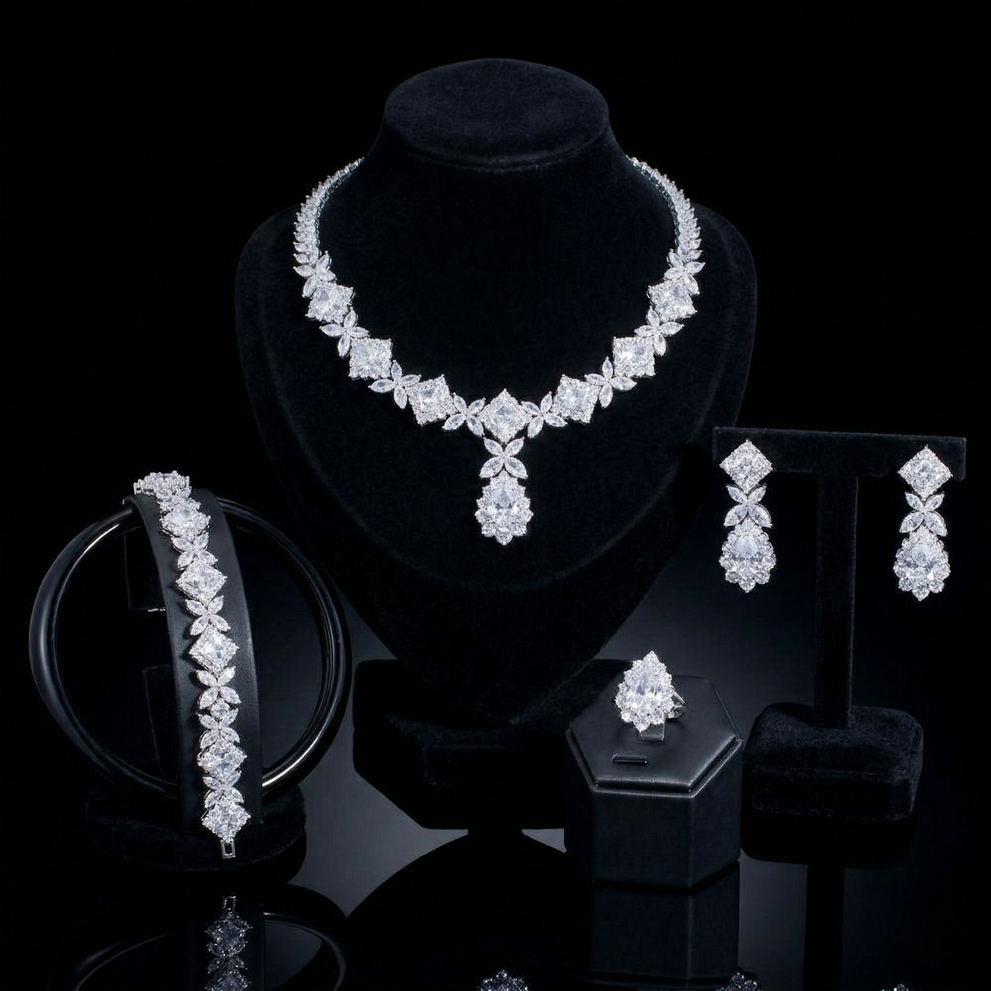 Luxurious statement jewelry set including a floral-inspired necklace, drop earrings, a matching bracelet, and a ring, all featuring brilliant marquise-cut white zircons.