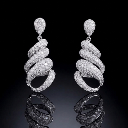 Luxurious silver-tone spiral earrings featuring dense pavé stone setting, captured against a pitch-black background with a crisp reflection on a glossy surface, highlighting high-end craftsmanship.