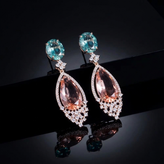Elegant teardrop statement earrings featuring soft peach and ocean blue stones in a refined, minimalist drop design.