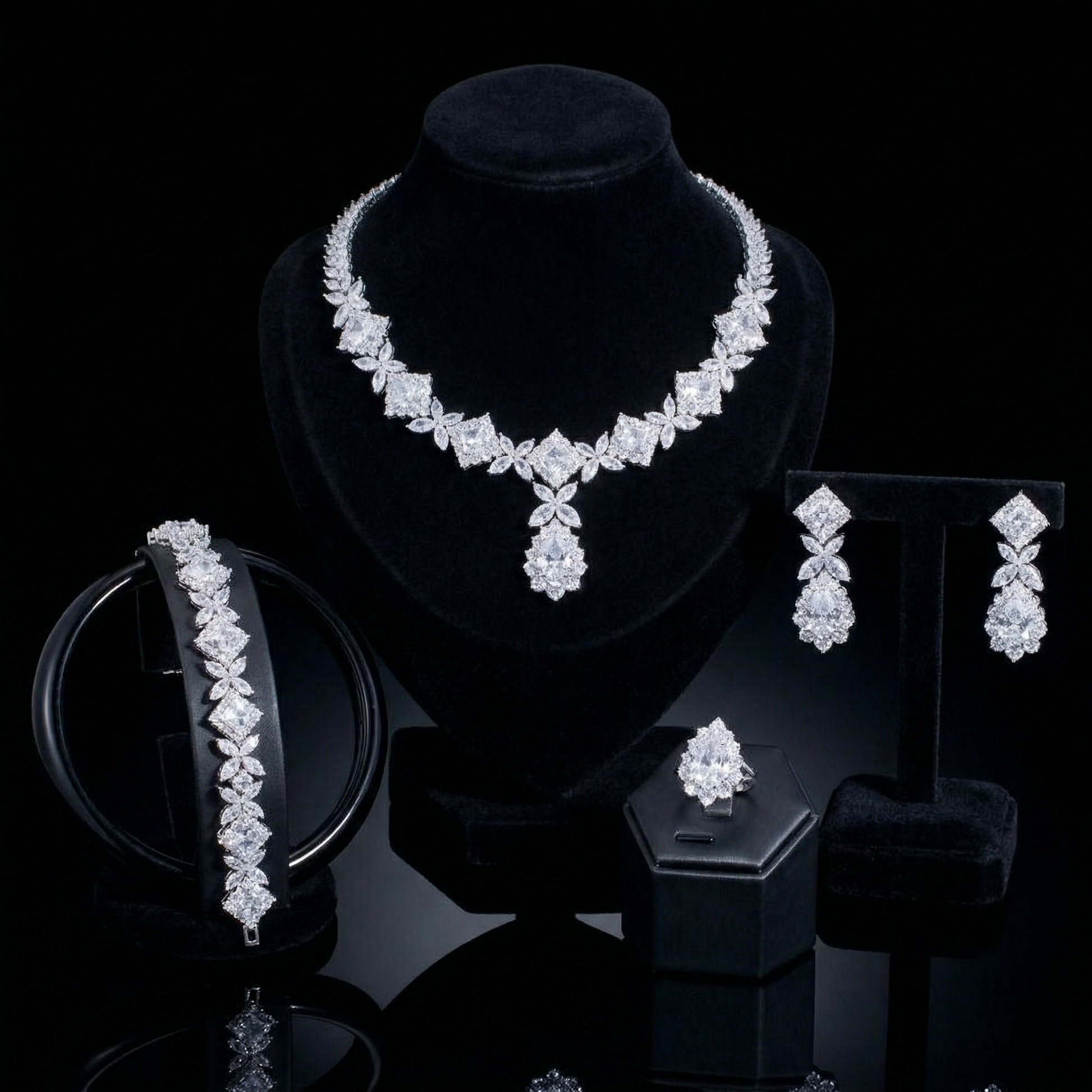 Luxurious statement jewelry set including a floral-inspired necklace, drop earrings, a matching bracelet, and a ring, all featuring brilliant marquise-cut white zircons.