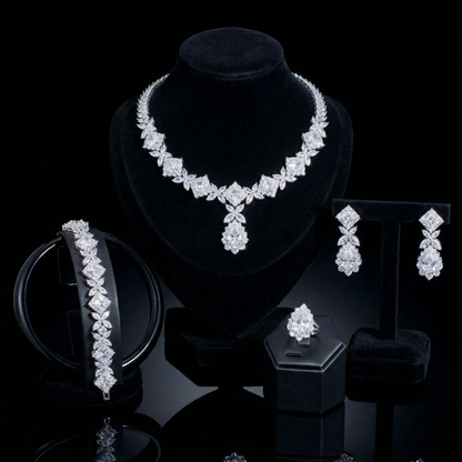 Luxurious statement jewelry set including a floral-inspired necklace, drop earrings, a matching bracelet, and a ring, all featuring brilliant marquise-cut white zircons.