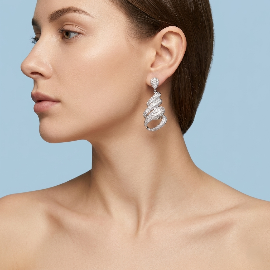 Profile view of a model showcasing silver spiral earrings with intricate stone detailing, styled with elegant, minimalist aesthetics on a flat, solid light blue background for a premium jewelry brand catalog.
