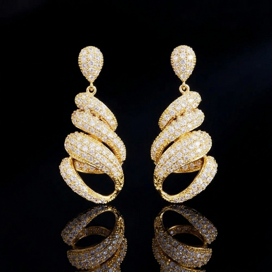 Elegant pair of gold spiral earrings encrusted with sparkling white stones, displayed on a reflective black surface with dramatic low-key studio lighting, creating a sophisticated and luxurious product presentation.