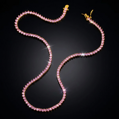 Exquisite pink stone tennis necklace featuring brilliant-cut gems set in a delicate chain, displayed on a sleek, pitch-black reflective surface for a high-end luxury jewelry presentation.
