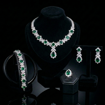 Luxurious statement jewelry set including a floral-inspired necklace, drop earrings, a matching bracelet, and a ring, all featuring brilliant marquise-cut white zircons.