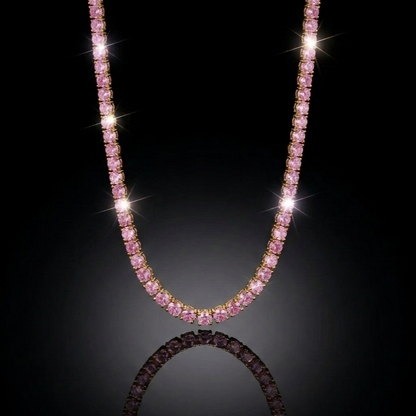 Luxury pink gemstone tennis necklace hanging in a symmetrical U-shape against a pitch-black background with dramatic lighting and a soft surface reflection.