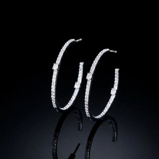 Elegant hoop earrings in a sleek silver-colored finish, fully embellished with a continuous line of sparkling, clear round-cut zirconias.