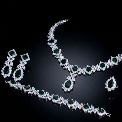 Luxurious statement jewelry set including a floral-inspired necklace, drop earrings, a matching bracelet, and a ring, all featuring brilliant marquise-cut white zircons.