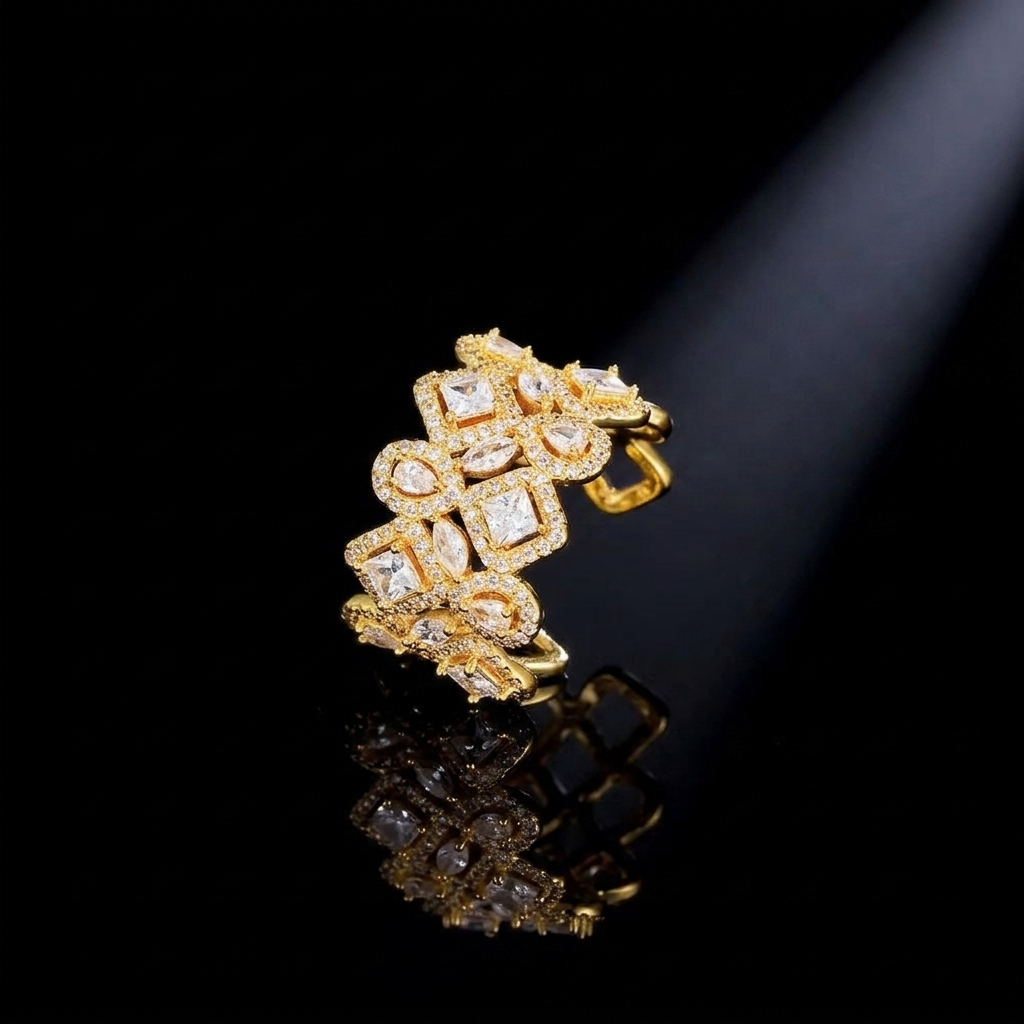A wide, intricately designed statement ring in a sleek gold-colored finish, featuring a geometric lattice pattern filled with sparkling, clear marquise and square-cut zirconias.
